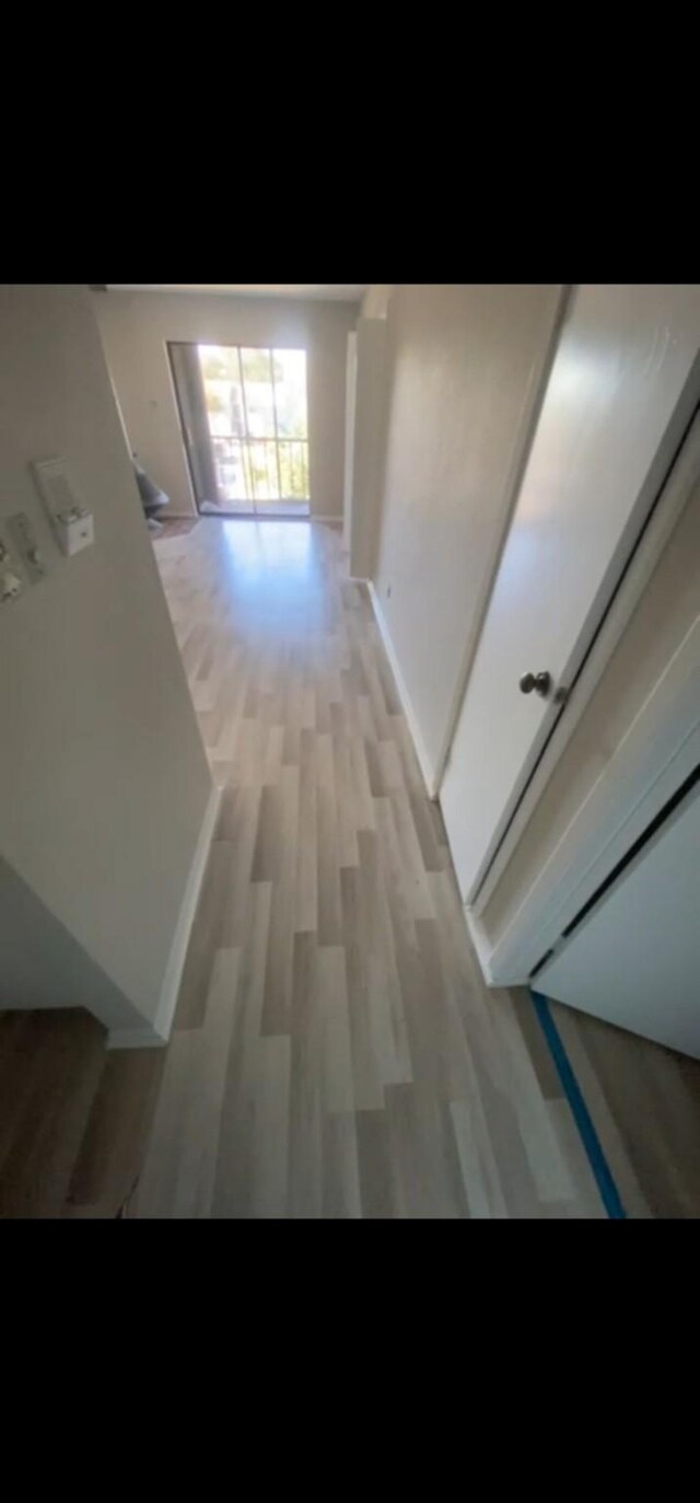 hall with light hardwood / wood-style flooring