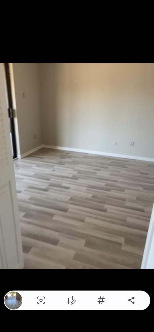 unfurnished room with light hardwood / wood-style floors