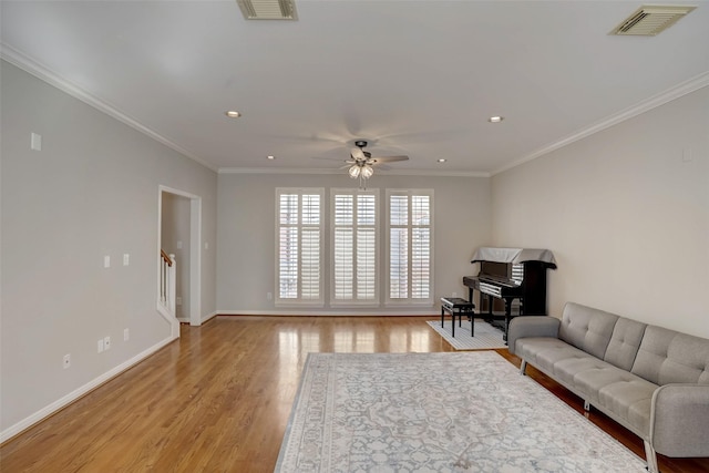 living room featuring light hardwood / wood-style floors, ceiling fan, and ornamental molding