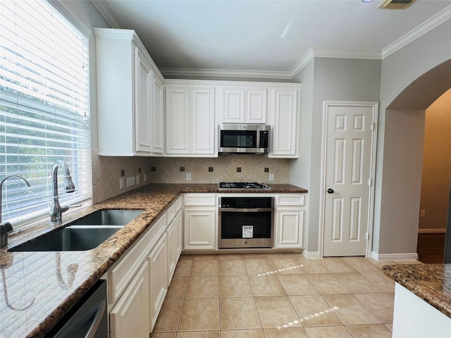 kitchen featuring stone counters, white cabinetry, sink, and appliances with stainless steel finishes