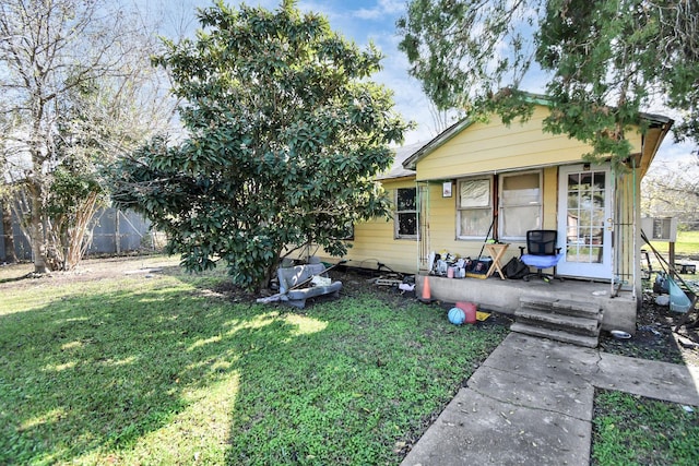 back of property featuring a yard