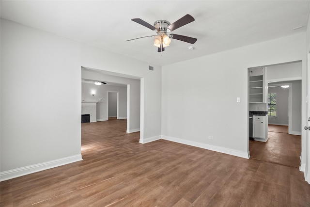 empty room with ceiling fan and hardwood / wood-style flooring