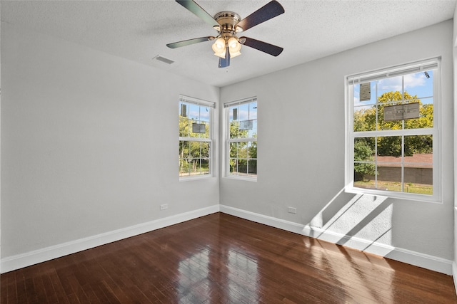 spare room with ceiling fan, hardwood / wood-style floors, and a textured ceiling