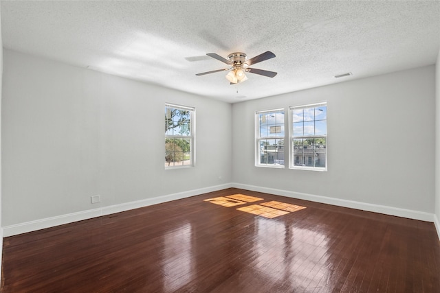 empty room with hardwood / wood-style floors, a textured ceiling, and ceiling fan