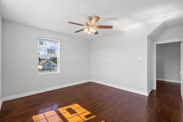 empty room featuring ceiling fan, dark hardwood / wood-style flooring, and a textured ceiling