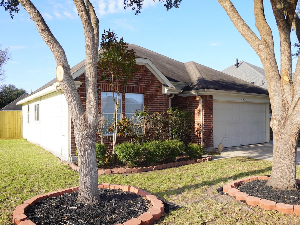 ranch-style house with a front yard and a garage