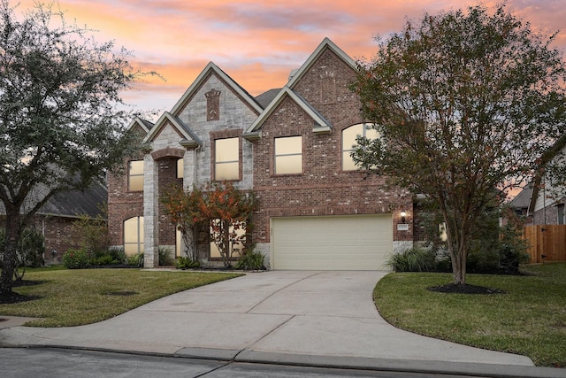 view of front of property featuring a yard and a garage