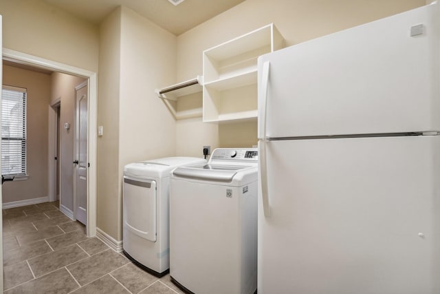 laundry area with light tile patterned floors and separate washer and dryer