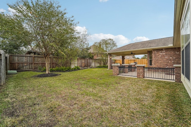 view of yard featuring area for grilling and ceiling fan