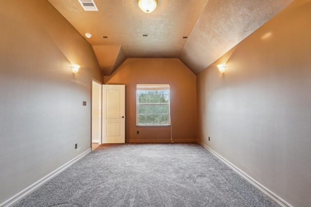 bonus room featuring carpet flooring, a textured ceiling, and vaulted ceiling