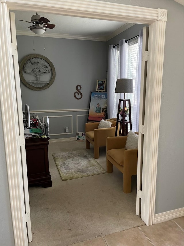 sitting room featuring light carpet, ceiling fan, and crown molding