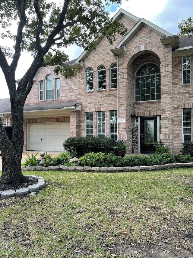 view of front of property with a garage and a front yard