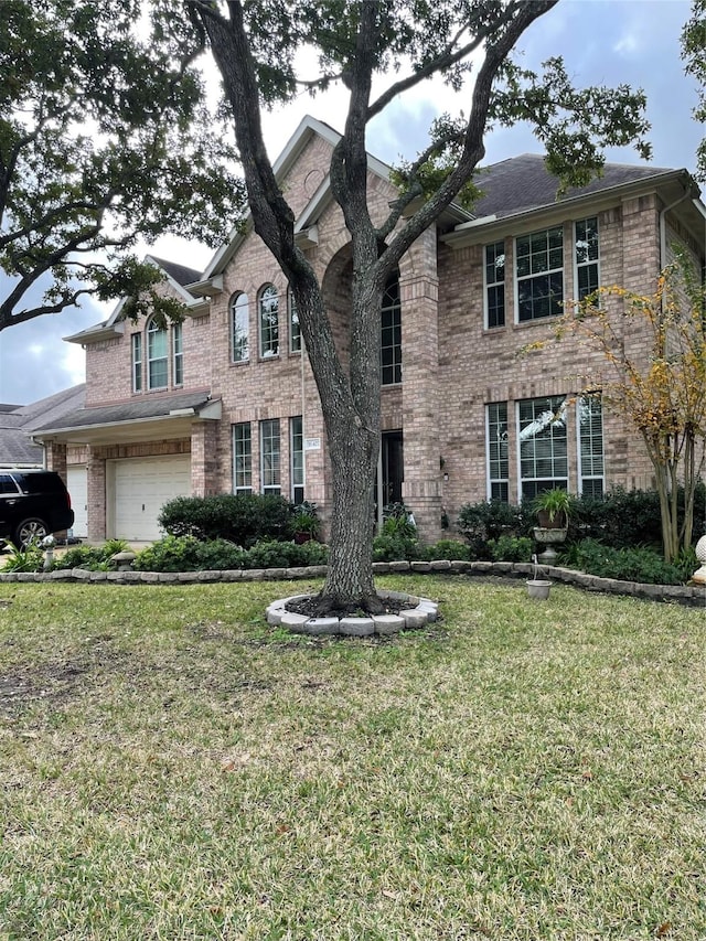 view of front facade with a garage and a front lawn