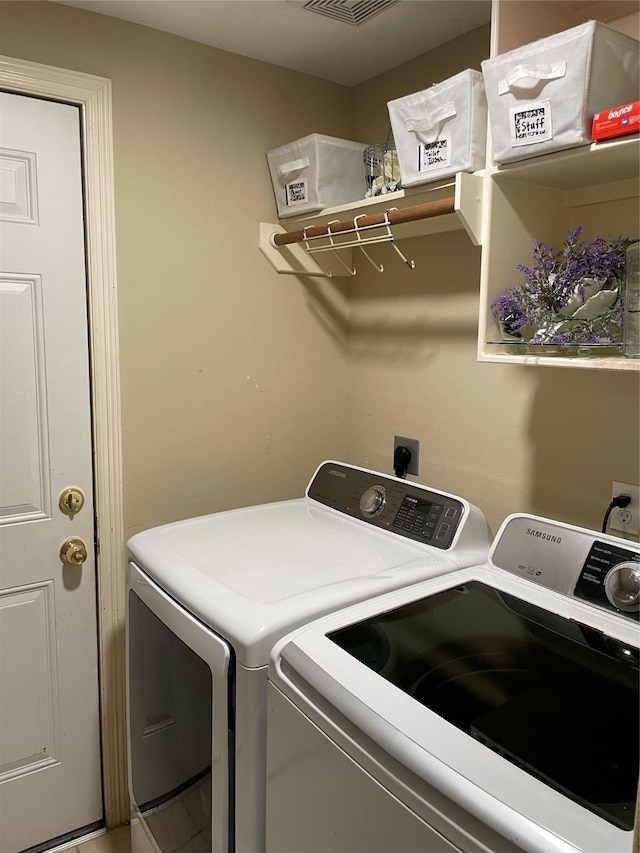 clothes washing area with washing machine and clothes dryer