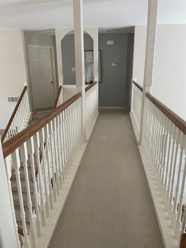 hallway featuring light carpet