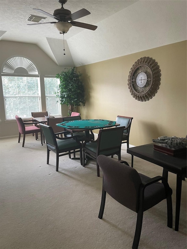 recreation room with a textured ceiling, ceiling fan, lofted ceiling, and carpet floors