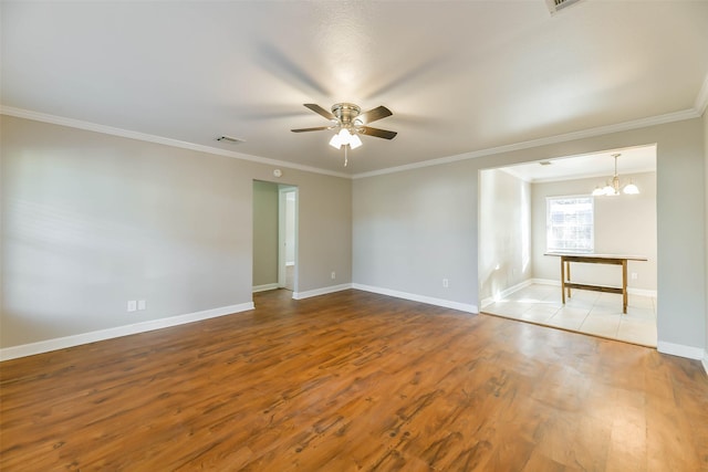 spare room featuring ceiling fan with notable chandelier, light hardwood / wood-style floors, and crown molding