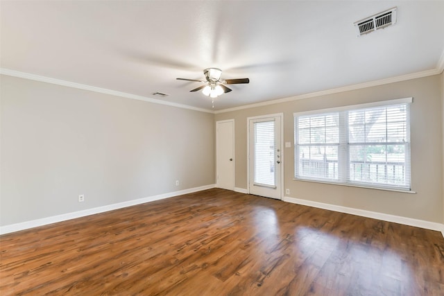 unfurnished room with ceiling fan, dark wood-type flooring, and ornamental molding