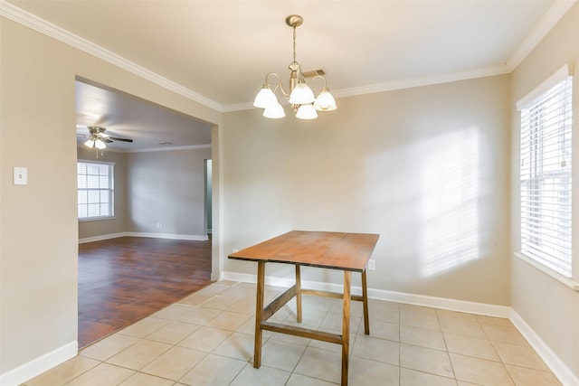 unfurnished dining area featuring ceiling fan with notable chandelier, crown molding, and light hardwood / wood-style flooring