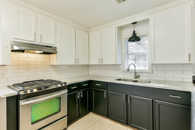 kitchen featuring stainless steel gas stove, white cabinetry, and sink