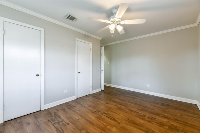 unfurnished bedroom featuring dark hardwood / wood-style flooring, ceiling fan, and crown molding