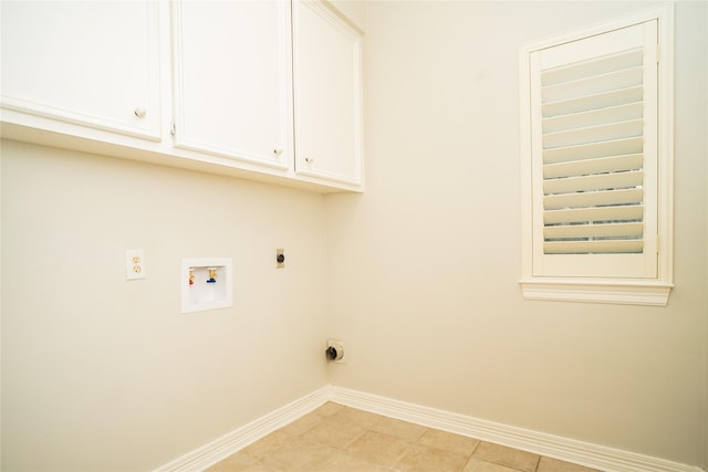 washroom with electric dryer hookup, cabinets, light tile patterned floors, and washer hookup