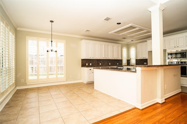 kitchen featuring white cabinets, light hardwood / wood-style flooring, and crown molding