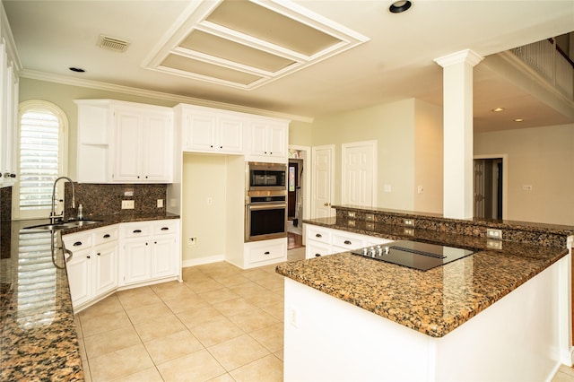 kitchen featuring white cabinetry, sink, appliances with stainless steel finishes, and dark stone counters