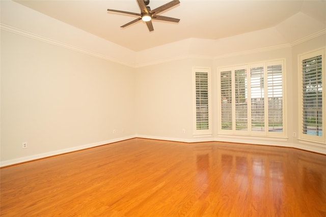 unfurnished room with ceiling fan, wood-type flooring, crown molding, and a tray ceiling