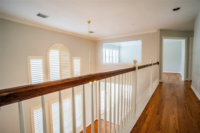 hallway featuring ornamental molding and dark wood-type flooring