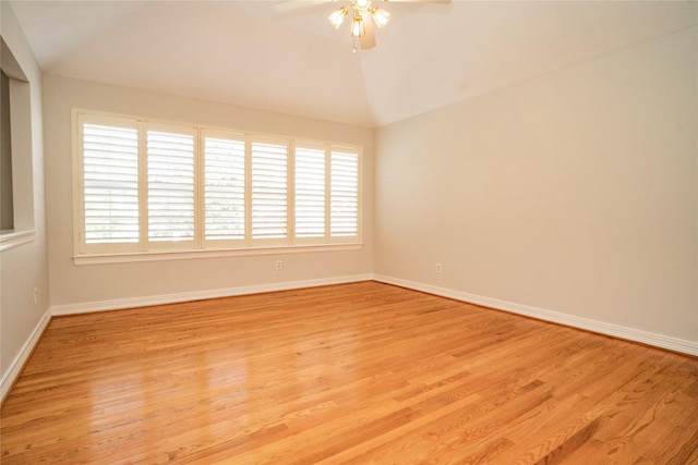 empty room with lofted ceiling, ceiling fan, and light wood-type flooring