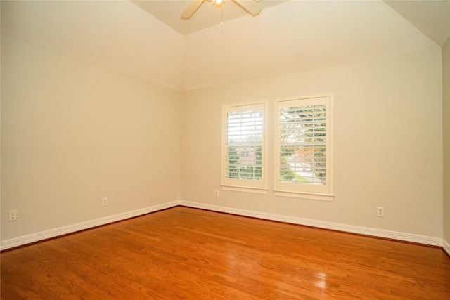 spare room with wood-type flooring, vaulted ceiling, and ceiling fan