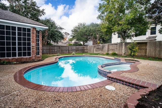 view of pool with an in ground hot tub