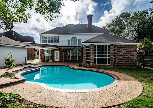 view of swimming pool with a patio area and an in ground hot tub