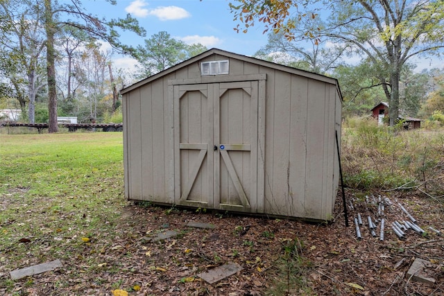 view of outbuilding with a lawn