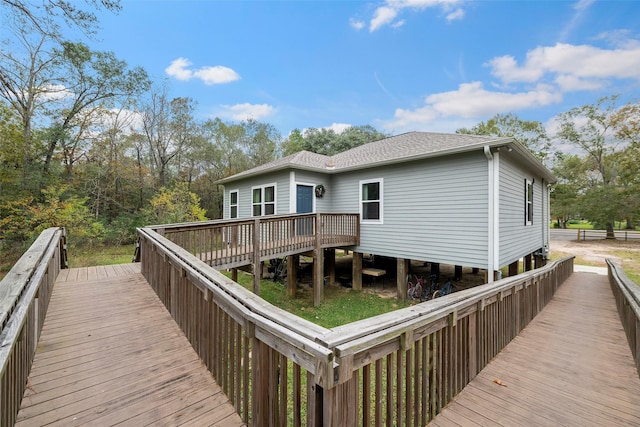 rear view of house featuring a wooden deck