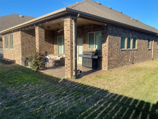 back of property featuring a lawn and a patio area