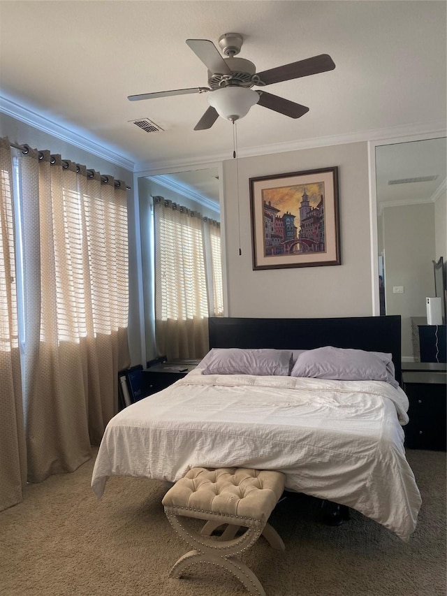 carpeted bedroom featuring ceiling fan and ornamental molding