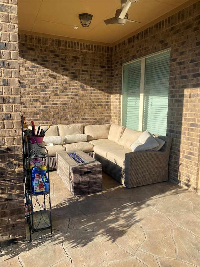 view of patio featuring ceiling fan and an outdoor living space with a fire pit