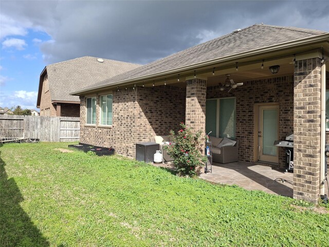 rear view of house featuring a yard and a patio