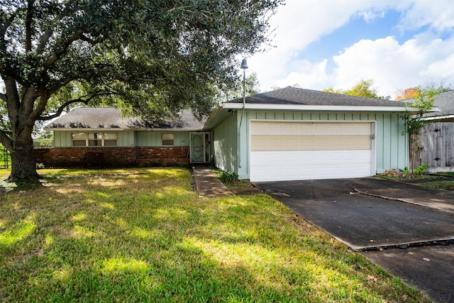 view of front of house with a garage and a front lawn