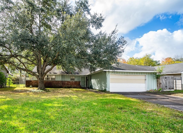 ranch-style home with a front yard and a garage