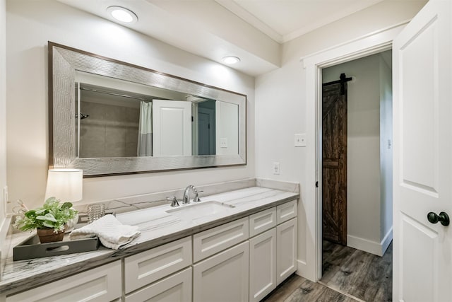 bathroom featuring a shower with curtain, vanity, wood-type flooring, and crown molding