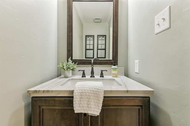 bathroom with vanity and ornamental molding