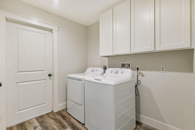 laundry area with cabinets, dark hardwood / wood-style flooring, and separate washer and dryer