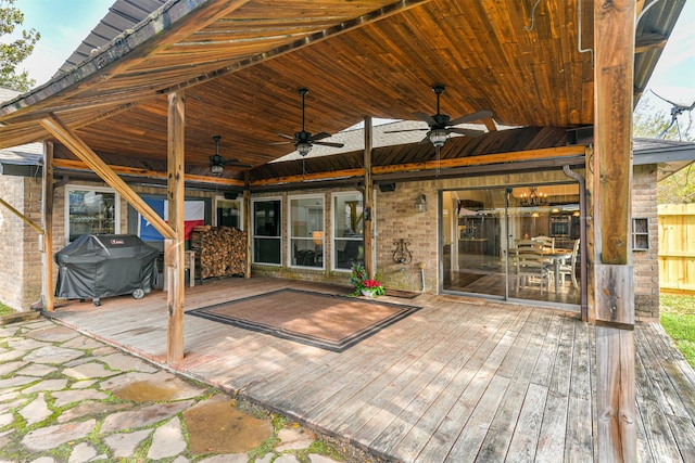 wooden deck featuring ceiling fan and area for grilling