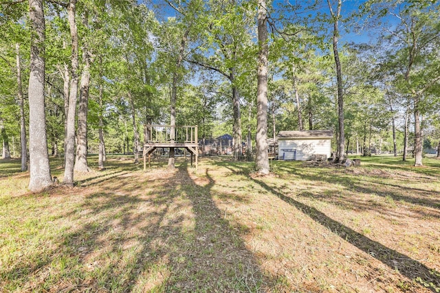 view of yard featuring an outbuilding and a deck