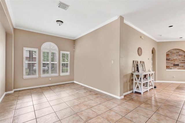 unfurnished room with ornamental molding and light tile patterned floors