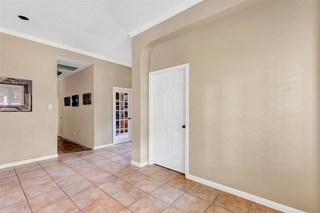 unfurnished room with light tile patterned floors and ornamental molding