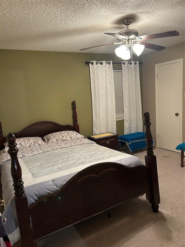 bedroom with carpet, a textured ceiling, and ceiling fan